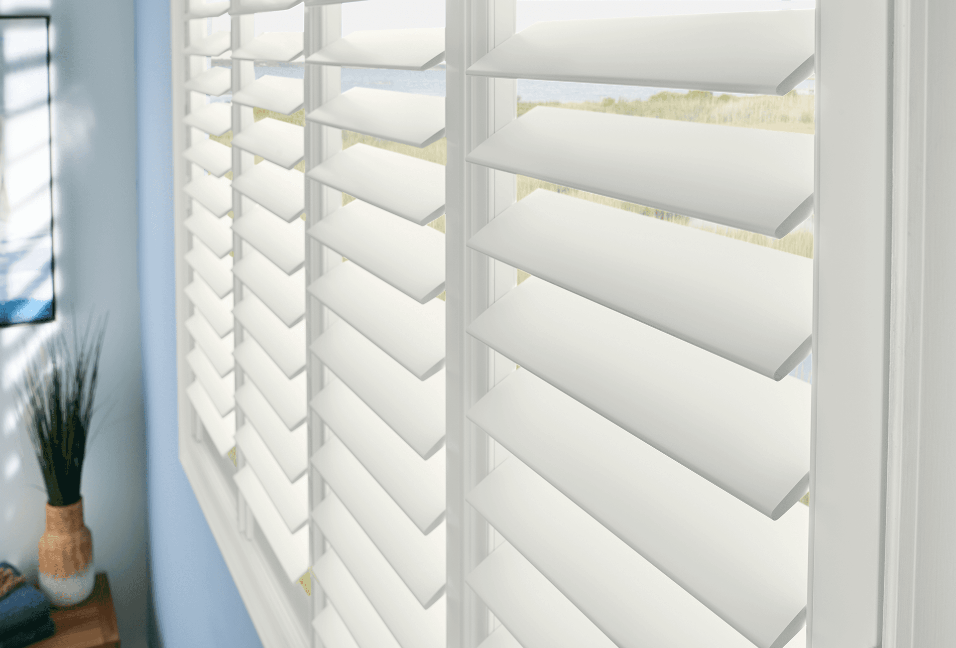 Composite shutters in white with hide-a-tilt hidden tilt control by Graber Blinds