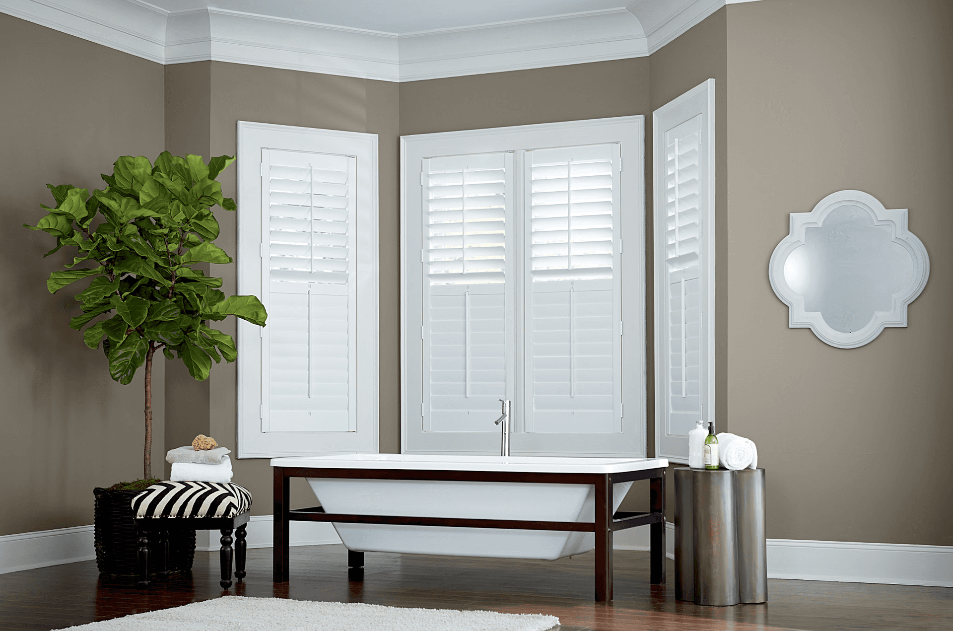 Composite shutters in Bay window with top and bottom split tilt operation by graber Blinds