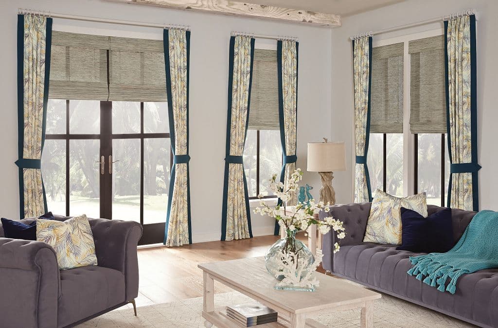 Horizons draperies with contrasting edge banding over natural roman shades