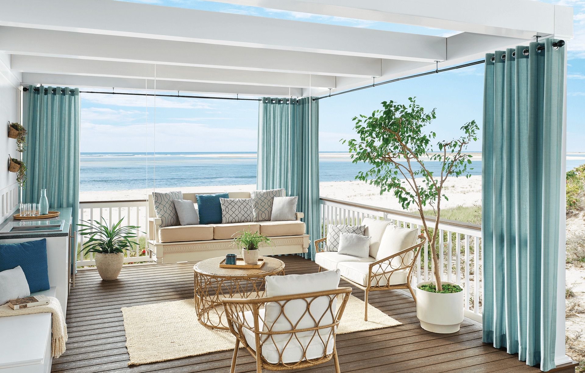 Exterior draperies in teal line a white pagoda and add beauty to this patio space