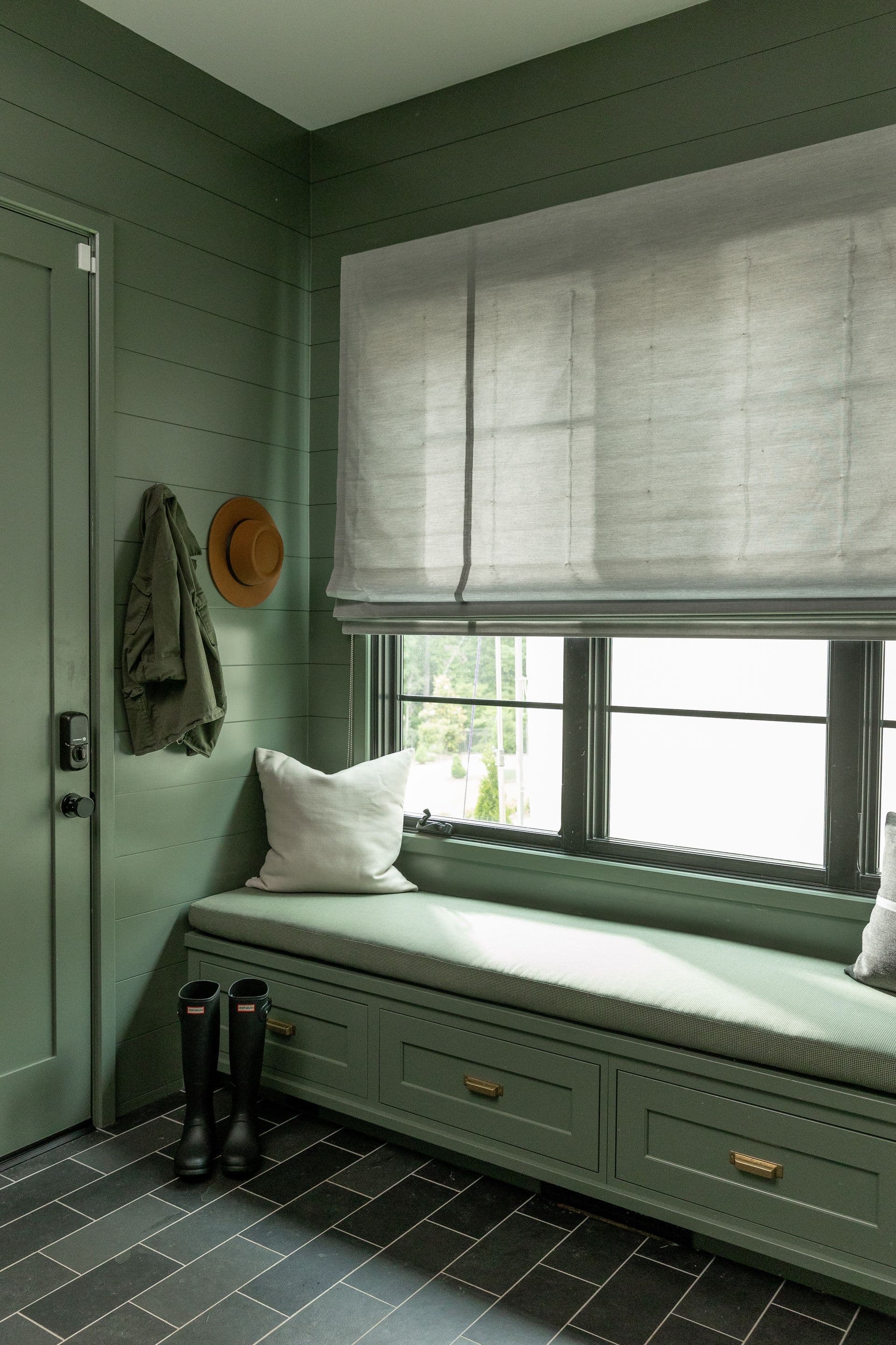 Soft Roman shades with beautiful texture above window seat via Sunbrella